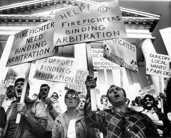 Firefighters with signs 