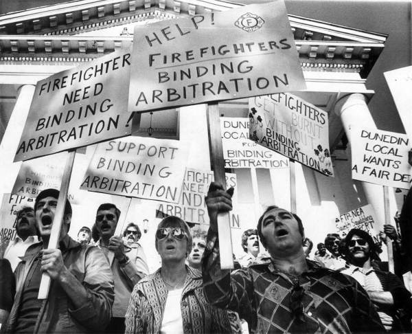 Firefighters with signs 