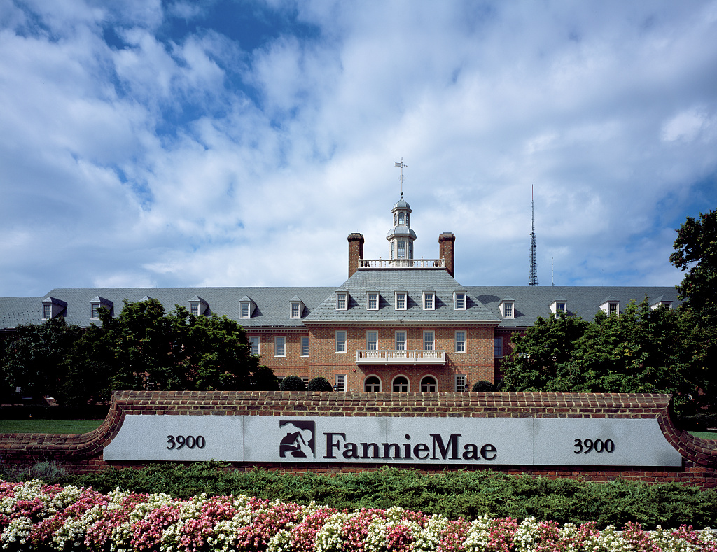 Brick building and sign decorated with flowers for the Fannie Mae headquarters building in Washington, D.C.